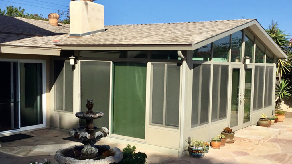 Custom sunroom with extensive glazing and landscaped exterior