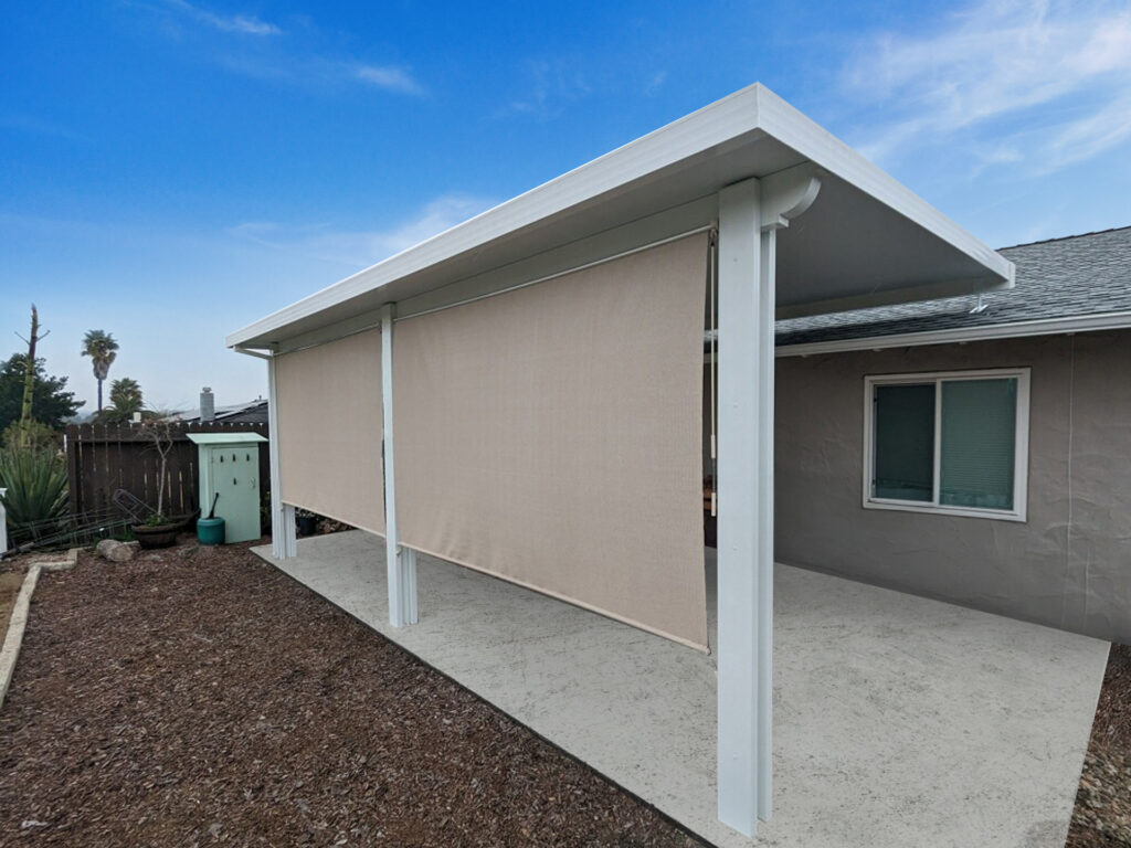 Aluminum shade structure covering a furnished backyard patio