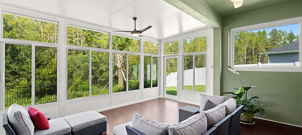 Studio sunroom with broad windows connected to a residential patio